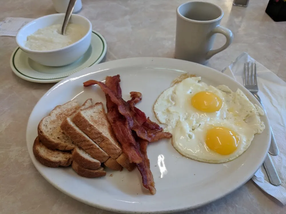 Two Eggs Sunny Side Up Wheat Toast and Bacon